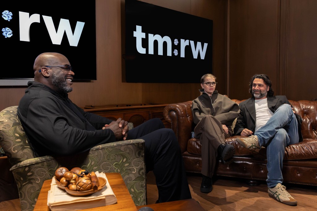 Shaquille O'Neal, Nathalie Bernce, and Jacov Nachtailer pose for a photo at tm:rw's Times Square location.