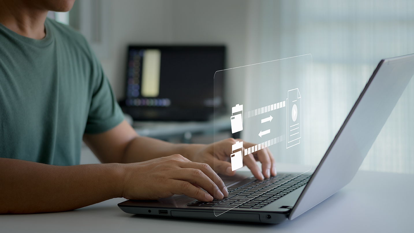 Business owner on a laptop with a secure data-transfer interface overlay